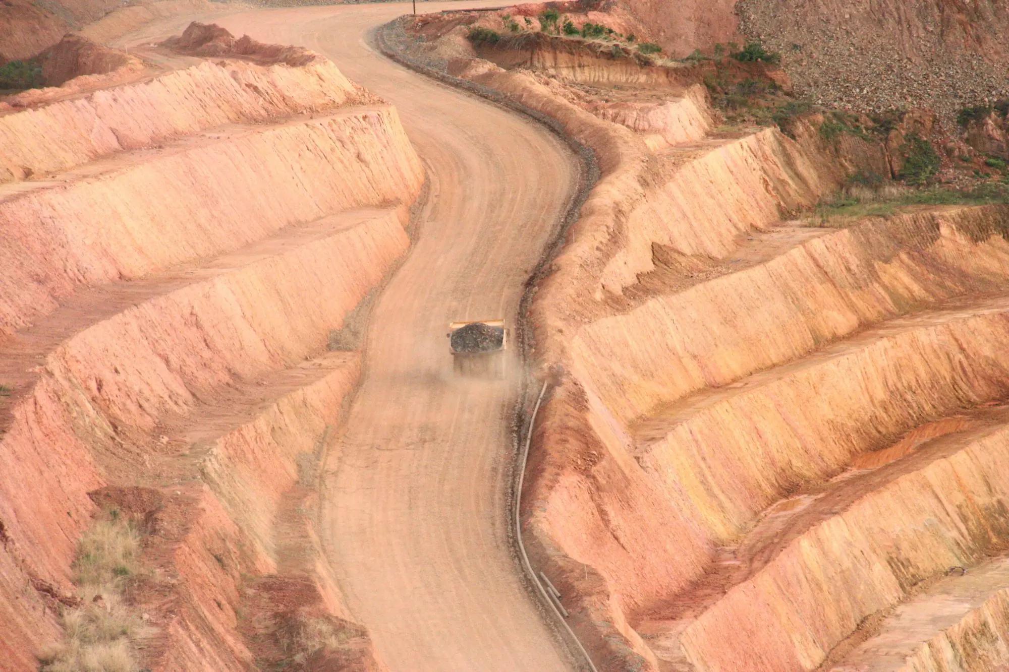 Haul truck carrying ore out of an open pit